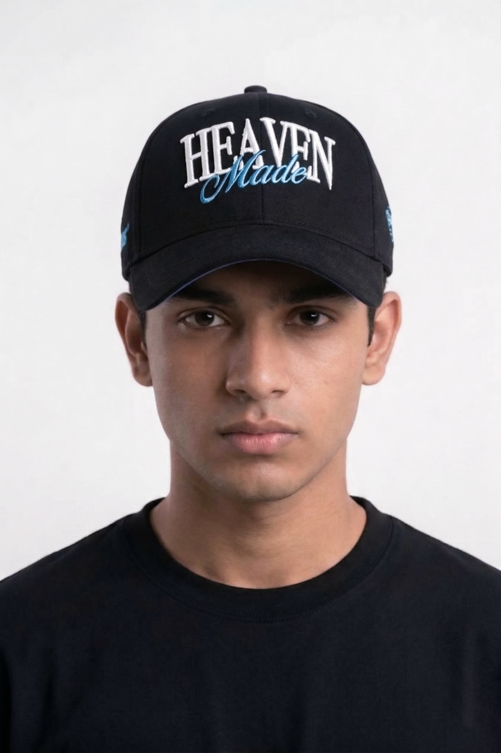 Person wearing black Heaven Made embroidered snapback cap, faith-inspired streetwear style